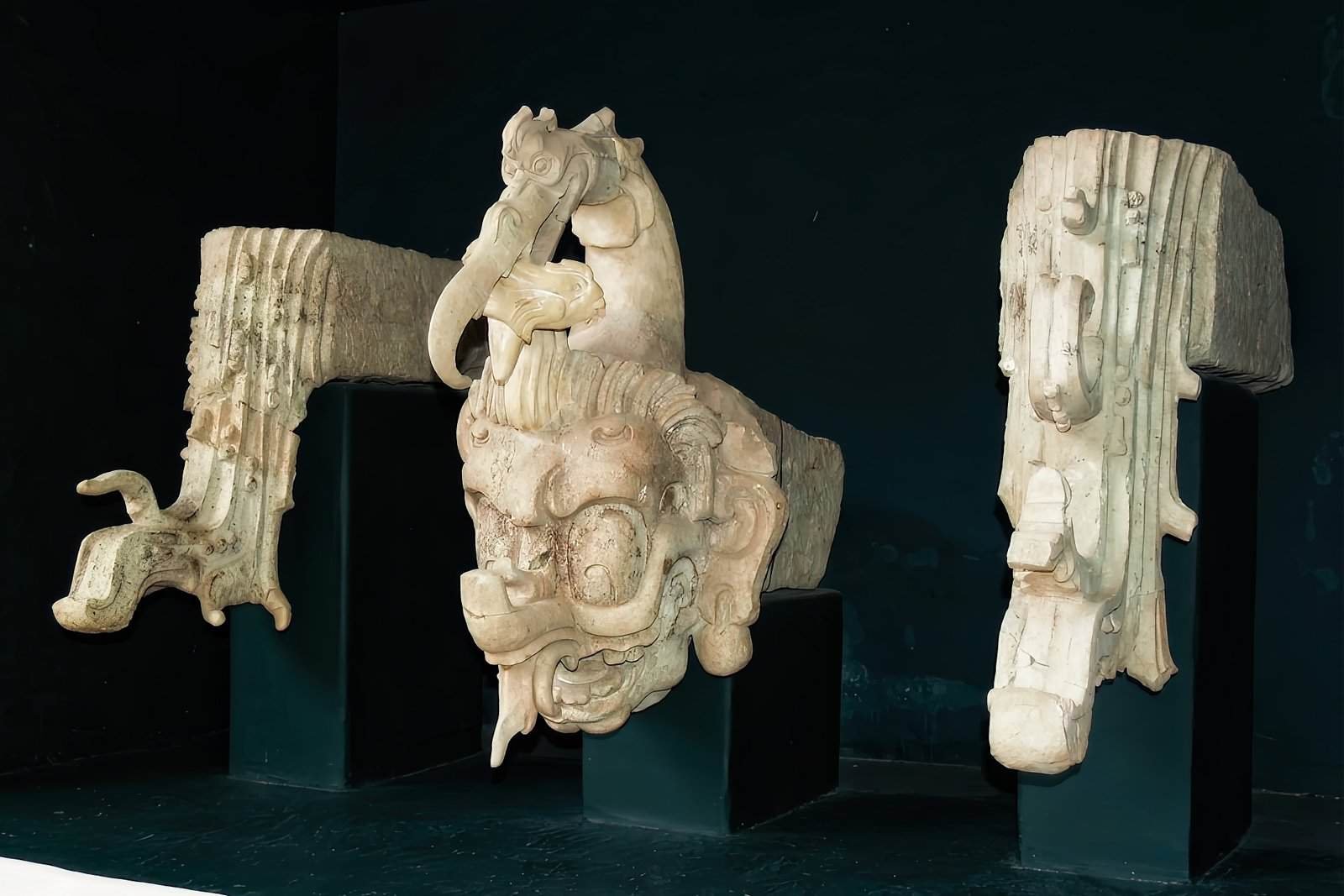 Intricate ancient Mayan stone carving of a fearsome mythical creature, displayed at the Copan Maya Sculpture Museum, just 5 minutes from Ancestral Copan Hotel
